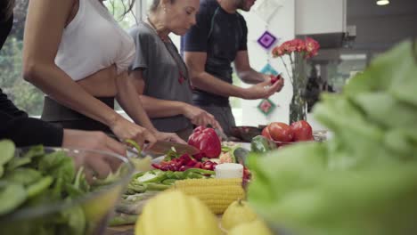 Cropped-shot-of-people-cooking-vegetables-in-kitchen